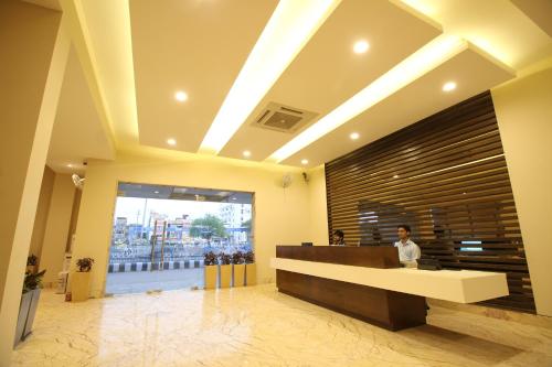 a lobby with a reception desk in a building at Hotel Le Roi Raipur at Raipur Railway Station in Raipur