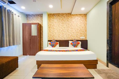 a bedroom with a large bed in a room at FabHotel Uday Vilas in Indore