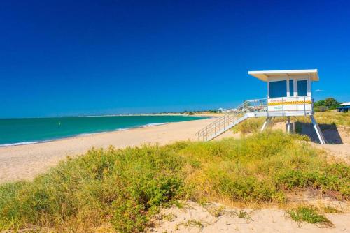 a lifeguard tower on a beach with the ocean at Ocean View Villa, 2 bedroom in Mandurah