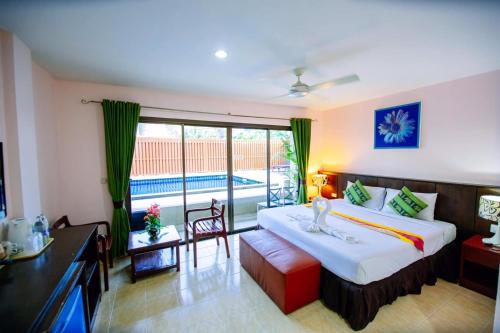 a hotel room with a bed and a balcony at Wanna Marine in Patong Beach