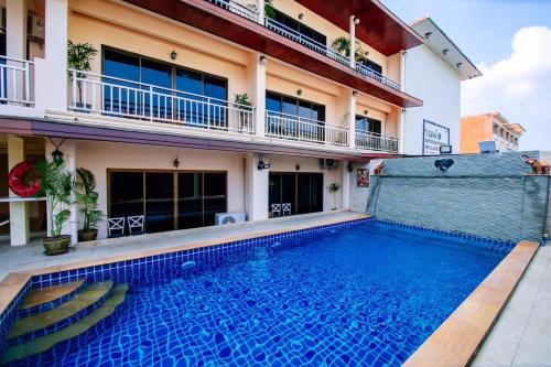 a swimming pool in front of a building at Wanna Marine in Patong Beach