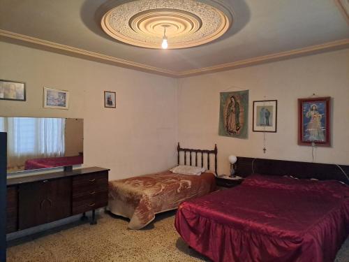 a bedroom with two beds and a large mirror at Casa Martha in Ciudad Nezahualcóyotl