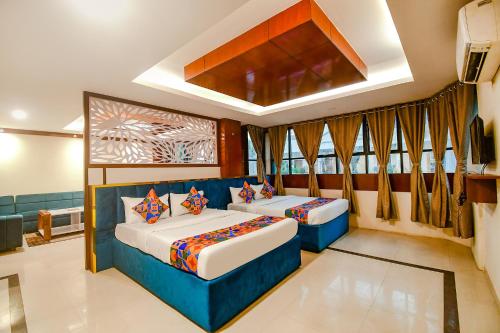 a bedroom with two beds in a room at FabHotel Greenland Grand - Nr Kalinga Stadium in Bhubaneshwar