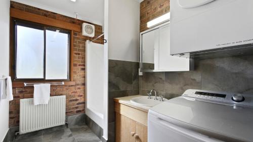 a small kitchen with a stove and a sink at Lawlers 17 in Mount Hotham