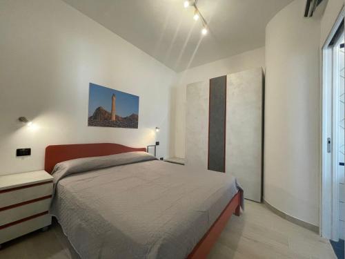 a bedroom with a bed and a large window at Casa Riviera in San Vito lo Capo