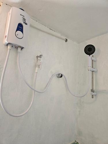 a shower in a bathroom with a hose at Antipolo Budget Hostel,Family Rooms in Antipolo
