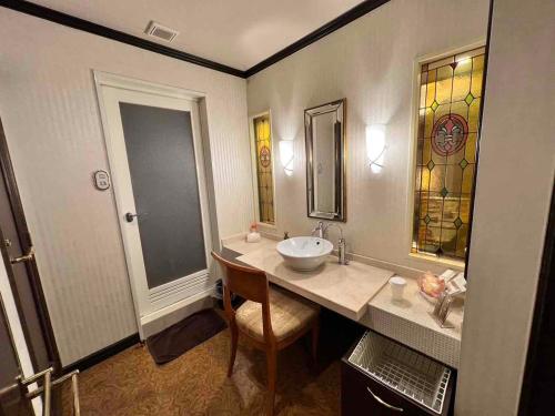 a bathroom with a sink and a mirror at HOTEL ULURU in Kobe