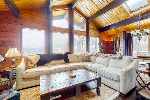 a living room with a couch and a table at Mountain View Chalet in West Dover