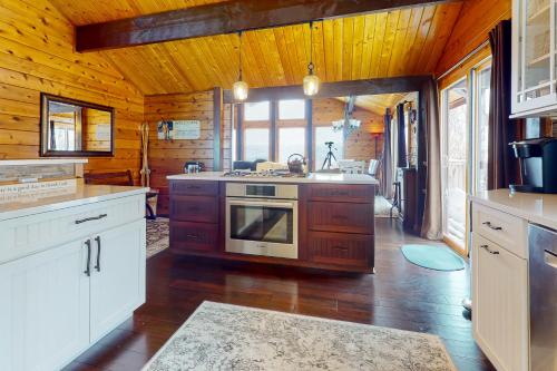 a kitchen with a stove top oven in a room at Mountain View Chalet in West Dover