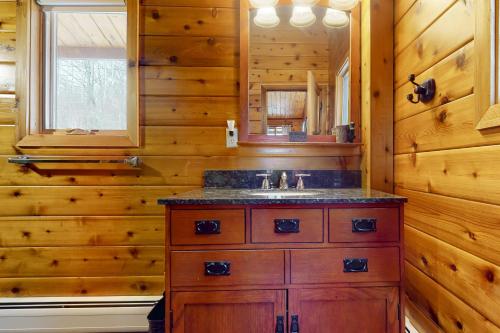 a bathroom with a sink in a log cabin at Mountain View Chalet in West Dover