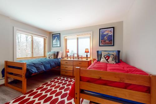 a bedroom with two beds and a window at Mountain View Chalet in West Dover
