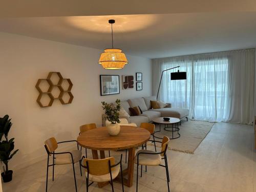 a living room with a table and a couch at Vanian Gardens Apartment -Stella in Estepona