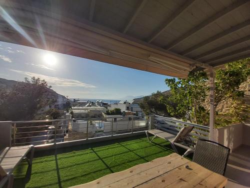 a patio with a table and chairs on a balcony at Villa Dream in Matala