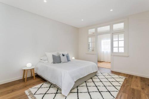 a white bedroom with a bed and a window at Coogee Beach 2 Bedroom Apartment - CG226 in Sydney