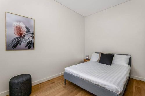 a bedroom with a bed and a picture on the wall at Coogee Beach 2 Bedroom Apartment - CG226 in Sydney