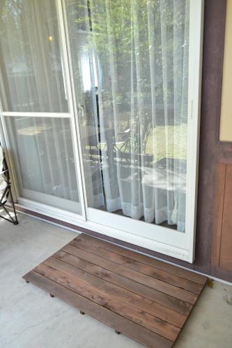 a sliding glass door with a mat in front of it at A private retreat Cotton Club Cottage in Takamori