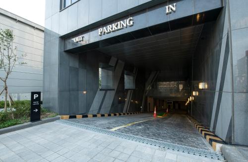 a building with the entrance to a parking garage at J One Hotel Cheongju in Cheongju