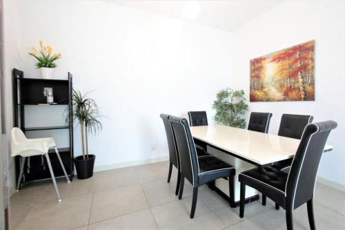 a dining room with a table and chairs at Afiniti Residensi Legoland Medini in Nusajaya