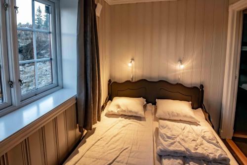 a small bed in a room with a window at Storsten 730 in Trysil