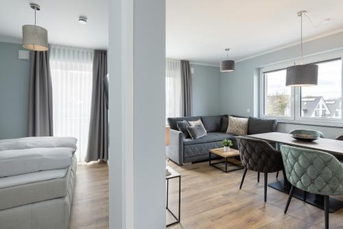 a living room with a couch and a table at Sturmfrei Suite 8 in Scharbeutz