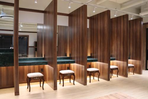 a row of bar stools in a room with wood dividers at Hotel tt Gupo in Busan