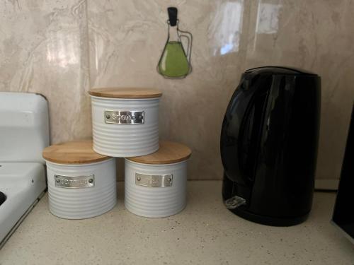 three stacks of plates sitting on top of a counter at Libby's Vacation Rental 2 Bed Home 1-4 Guests in Nadi
