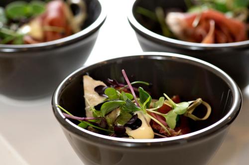 a group of four bowls of food on a table at Golf Hotel Viborg in Viborg