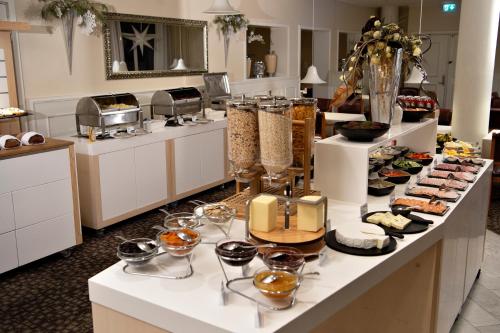 a buffet of food on a counter in a kitchen at Golf Hotel Viborg in Viborg