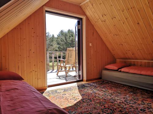 a room with a bed and a sliding glass door at Metsaräägu Wellness in Ulendi