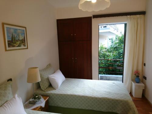 a bedroom with a bed and a large window at Sunny family apartment in Chania close to the sea in Chania Town