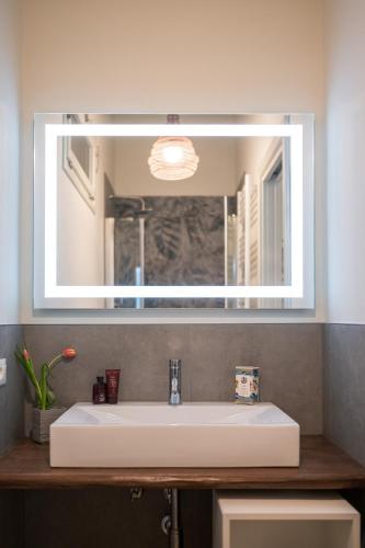 a bathroom sink with a large mirror above it at CasadiMaru in Pietrasanta