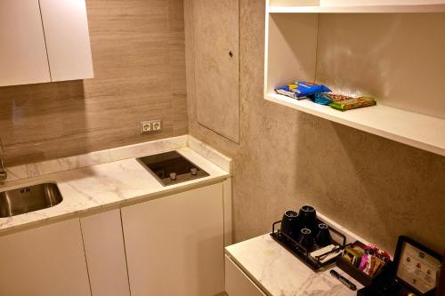 a small kitchen with a sink and a counter at Lara Barut Collection-Ultra All Inclusive in Lara