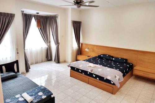 a bedroom with two beds and a window at Puchong Landed Homestay - 1st unit @ BKT Puchong in Puchong