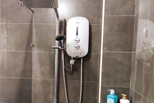 a shower with a white soap dispenser in a bathroom at Puchong Landed Homestay - 1st unit @ BKT Puchong in Puchong