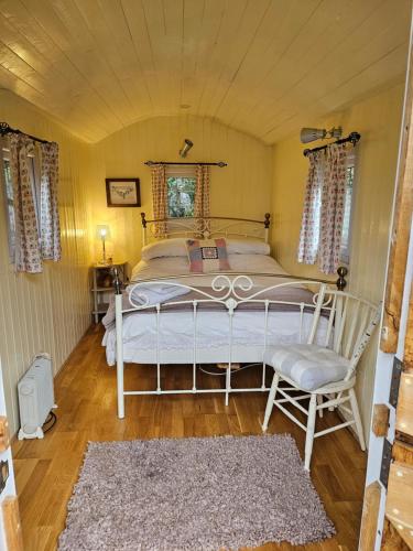 a bedroom with a large bed in a room at Glamping At The Fox Inn Bramdean in Bramdean