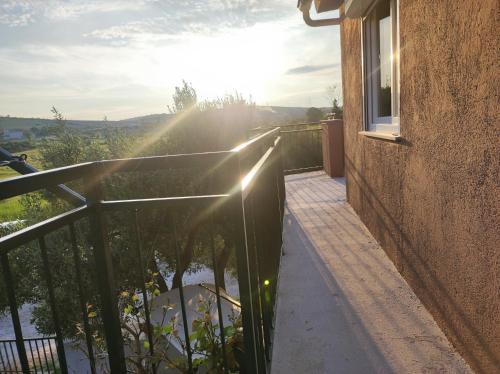 a balcony of a building with the sun shining at Holiday House Mablo with pool & jacuzzi in Šibenik
