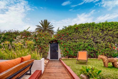 a garden with a wooden pathway leading to a door at Signature Agadir Villa Luxe for 4 or 6 PX in Agadir