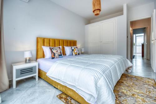 a bedroom with a large bed with a wooden headboard at Signature Agadir Villa Luxe for 4 or 6 PX in Agadir