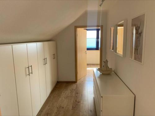 a white kitchen with a counter and a window at Fewo-Hürtgenliebe in Hürtgenwald