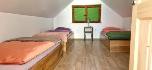 a bedroom with two beds and a window at Bled Straza House in Bled