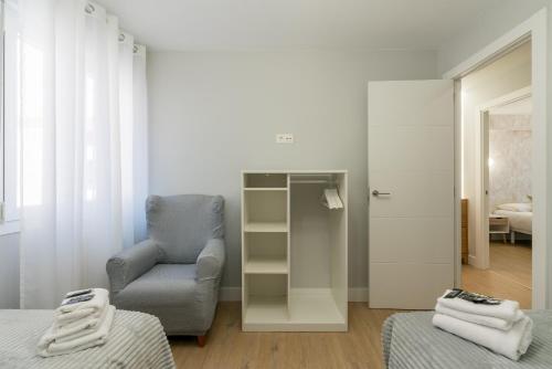 a living room with a chair and a chair at Villa Hita apartment by People Rentals in Bilbao