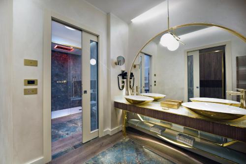 a bathroom with two sinks and a large mirror at Vip's Motel Luxury Accommodation & Spa in Lonato del Garda