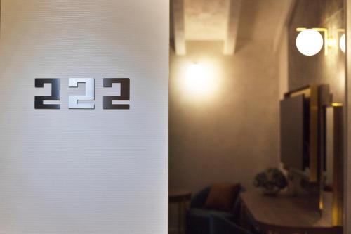 a white wall with the numbers on it at Vip's Motel Luxury Accommodation & Spa in Lonato del Garda