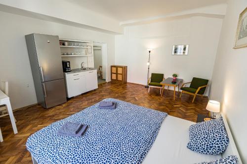 a room with a bed and a kitchen and a room with a kitchen at Best View Apartments in Bratislava