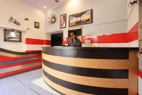 a man sitting at a bar in a restaurant at OYO Hotel Vanshika in Agra