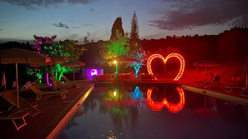 a swimming pool with christmas lights in a yard at Antiqua Vallis in Palaia