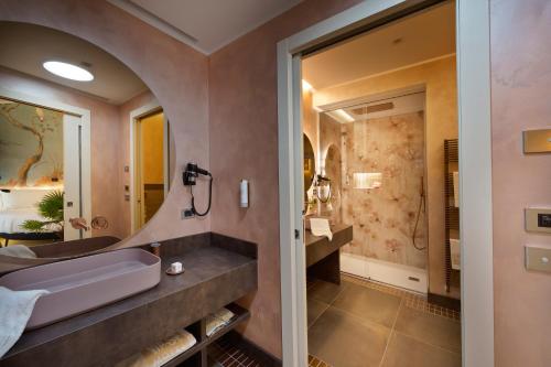 a bathroom with a sink and a shower at Vip's Motel Luxury Accommodation & Spa in Lonato del Garda
