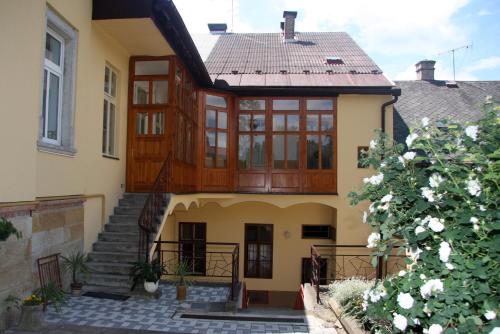 a house with a staircase in front of it at Apartmán Husova 1.patro in Jičín