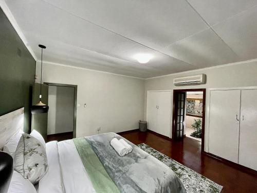 - une chambre avec un grand lit dans l'établissement Cozy 3 Bedroom House with unique bathrooms - 2084, à Bulawayo