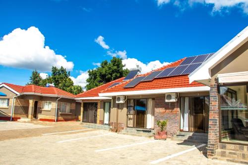 a row of houses with solar panels on their roofs at Standard room in Morningside guesthouse - 2090 in Bulawayo
